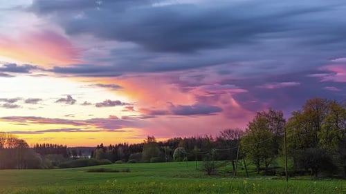 Timelapse of colourful clouds moving over rural landscape