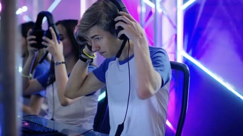 Team of Teenage Gamers Get Ready for eSport Tournament, Put on Their Headsets. Tournament Area/ Int