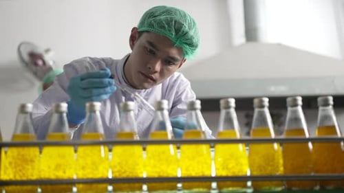 L'employé travaille dans une usine de boissons.