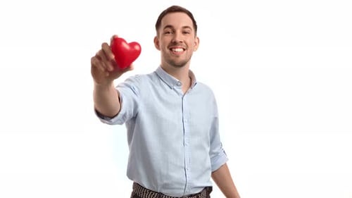 Man Smiling and Holding Heart