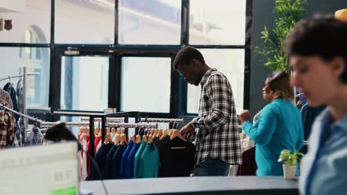 Customer Looking at Hangers with Shirt