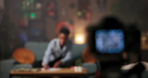 Business Consultant Corporate Trainer African Woman in Living Room Engages with Camera Discussing