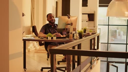 Enthusiastic Man at Computer in Modern Office