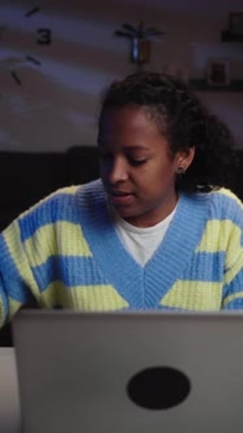 Woman Types Credit Card Info Into Laptop At Night