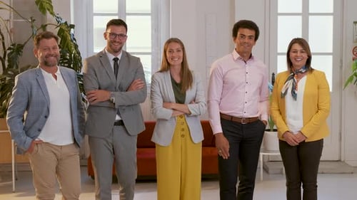 Portrait of business people standing in office and looking at camera.