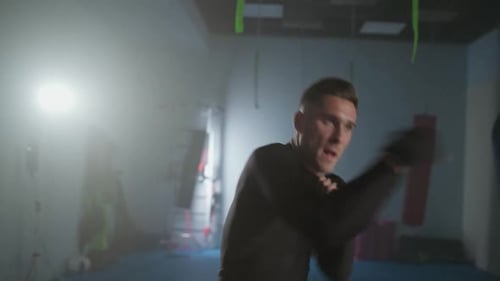 Handheld Professional Fighter Trains His Punches and Defense in the Boxing Gym a Boxer Trains in