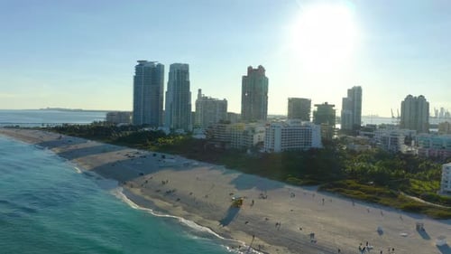 Aerial panoramic view of high rise buildings along sea coast.
