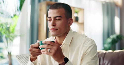 Man Sips Warm Drink at Home