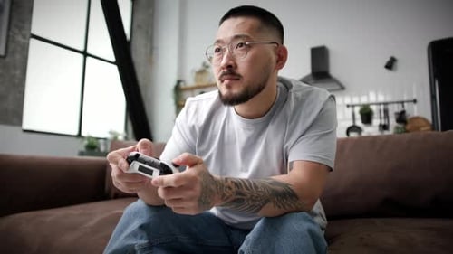 Focused Man Playing Video Game at Home