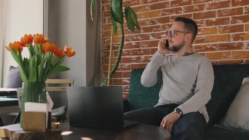 Young Man 30s Wear Casual Clothes Sits Alone at Table in Coffee Shop Cafe Work on Laptop Pc Chatting