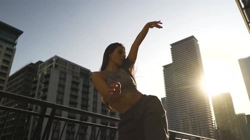 Young Woman Dancing Gracefully in an Urban Setting
