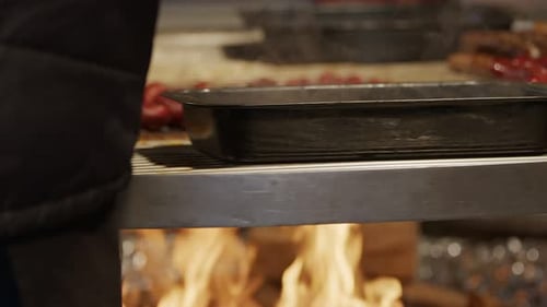 Hot Dogs Cooking on a Metal Grate