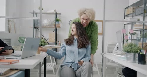 Joyful Man and Woman Riding Chair Having Fun in Crazy Office Relaxing During Break