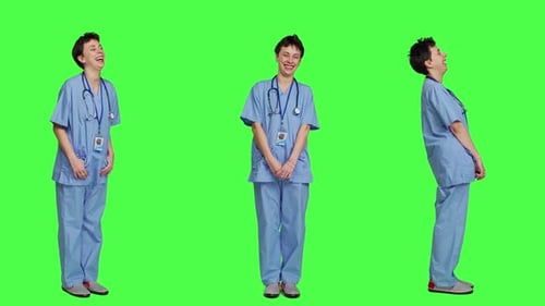Cheerful Smiling Medical Assistant Standing Against Greenscreen Backdrop