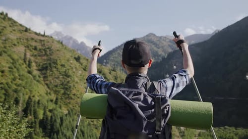 View From Behind of a Senior Tourist with a Backpack Looking at the Nature and Enjoying His Hiking