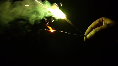 Sparklers Burning and Emitting Smoke in the Dark