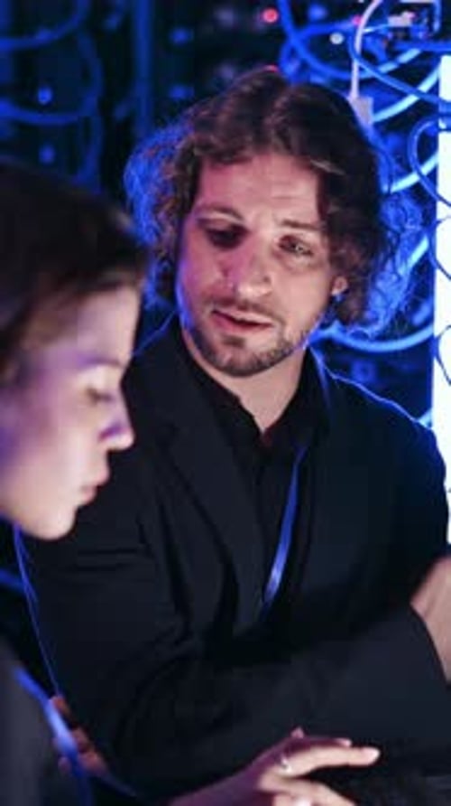 Colleagues Work in Modern Server Room