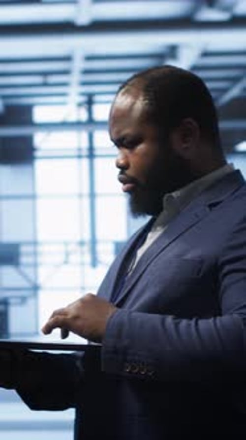 Vertical Video Computer Scientist in Server Hub Checking Recovery Plan on Laptop