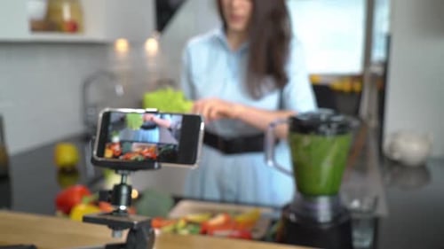 Woman Creates Cooking Video in Modern Kitchen