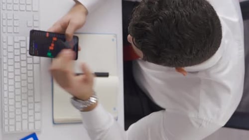 Trader Analyzes Stock Chart on Mobile Device
