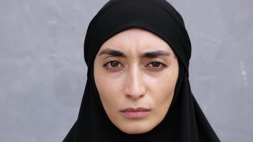 Close Ap Face of Serious Oppressed Feminist Woman in Muslim Country A Brunette Woman in Hijab Looks