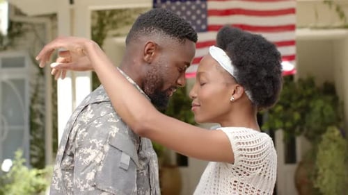 Loving Couple Embrace in front of American Flag