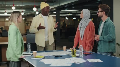 Diverse Team Celebrates Success in Modern Office