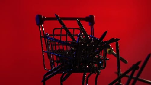 Screws Filling a Shopping Cart on Red Background