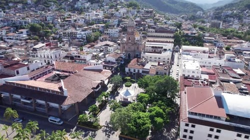 Drone flight from the Puerto Vallarta boardwalk to the town's church, focused on the church as the m