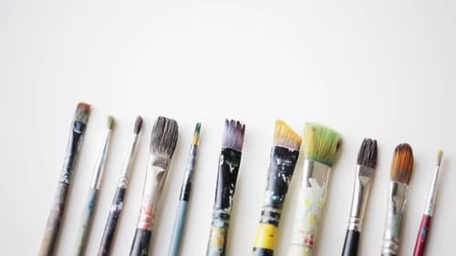 Art, Creativity and Tools Concept - Messy Palette Knives and Paintbrushes Activity