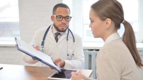 Doctor Explains Medical Report to Female Patient