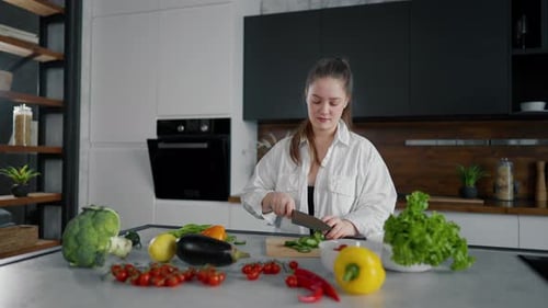 Woman Preparing Fresh Vegetables in Modern Kitchen