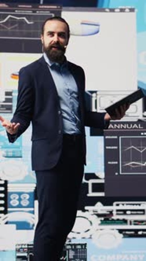 Corporate Man Presents Data on Multiple Screens