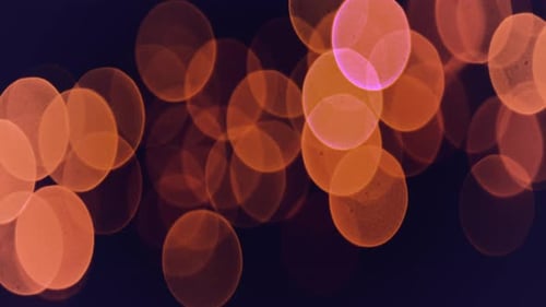 Orange bokeh lights shine brightly