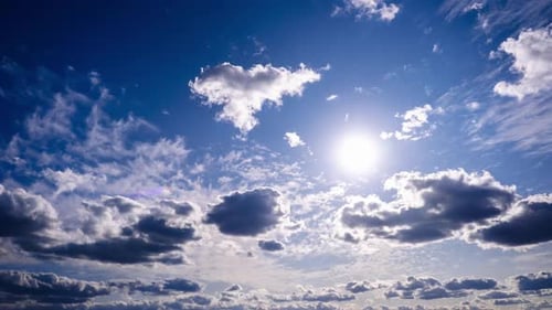 Timelapse of Cumulus Clouds Moving In The Blue Sky Against The Sun