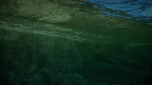 Underwater View With Surface Ripples And Dark Depths