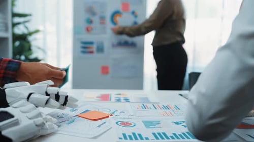 Business Team Discusses Data with Robot in Office