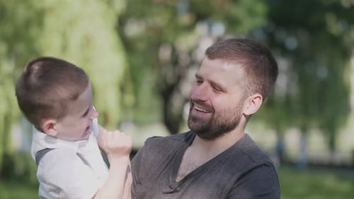 Father and Son Embracing Outdoors with Joy