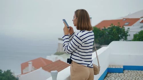 Girl Taking Smartphone Pictures at Sea Town. Focused Blogger Exploring City Create