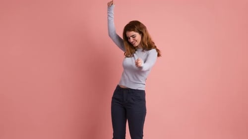 Smiling Young Woman Dancing in Bright Studio