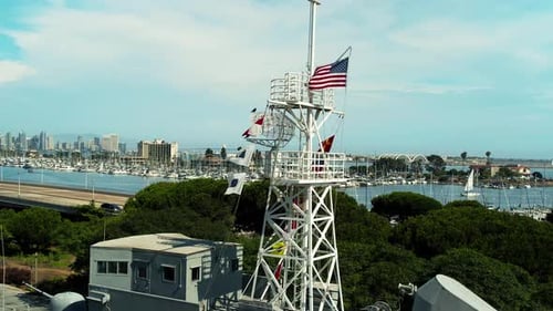 American Flag in wind on the USS Recuit; a Navy monument depicting a warship which overlooks the bay