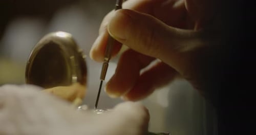 Watchmaker Repairing a Vintage Gold Pocket Watch