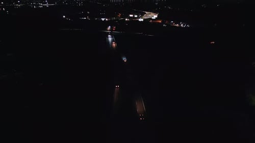 Aerial View of Night Freeway Without Street Lights with Cars