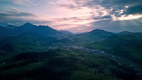Aerial Hyperlapse Spring Alps Mountainsfluffy Cloudsgreen Meadows and Blooming Trees in the Valley