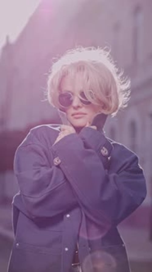 Stylish Woman Posing in Urban Setting with Sunglasses