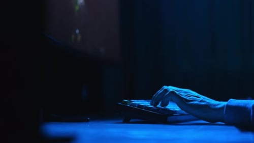 Closeup Hands of Unrecognizable Gamer Pushing Keyboard and Mouse Buttons While Playing Online