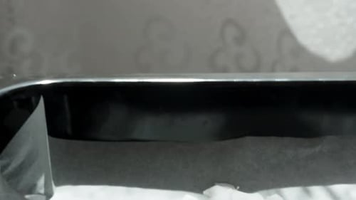 Shredded Coconut Being Poured onto Baking Sheet