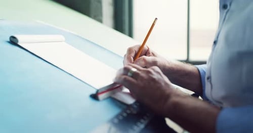 Professional architect working on architectural sketches in bright office space