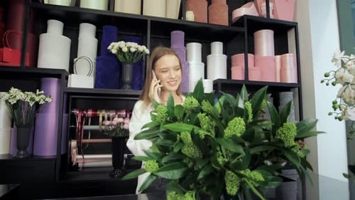 Woman Talking on Phone in Flower Shop
