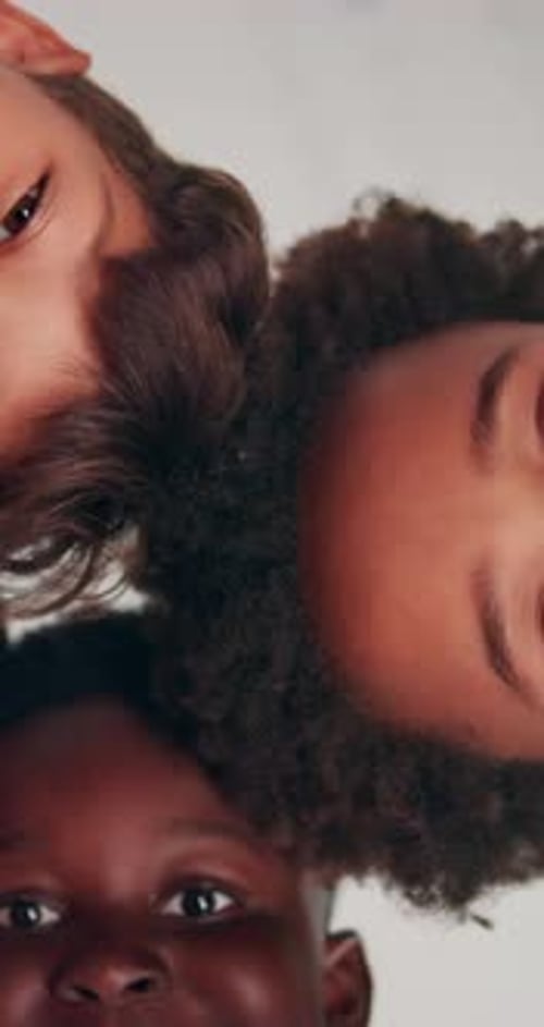 Happy, low angle and face of children in circle for friendship, community and support